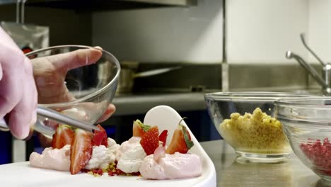 close up of woman hands while preparing strawberry dessert
