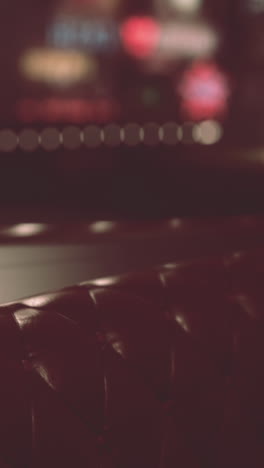 red leather couch in a dark room with blurred lights