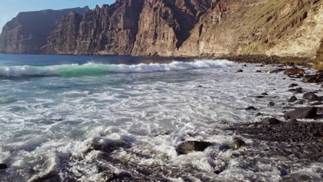 Flying-Over-Rocky-Beach-At-Tenerife,-Los-Gigantes,-Puerto-De-Santiago-Playa-De-Los-Guios