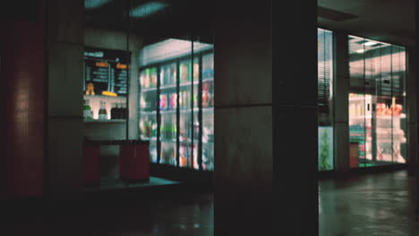 a store front with rain drops on the window at night