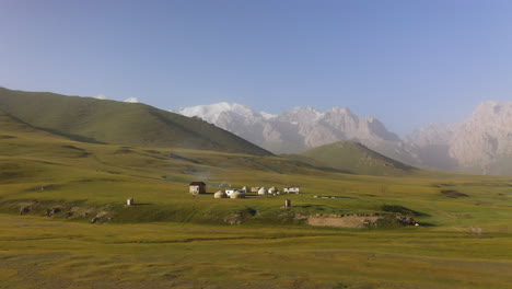 Rotating-drone-shot-of-a-Yurt-campsite-near-the-Kurumduk-river-in-Kyrgyzstan