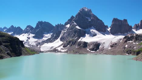 beautiful drone footage of a lake surrounded by the peaky mountains in the himalayan region of kashmir - chitta katha lake