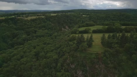 high altitude aerial view with backward movement about a forest in mayenne, france