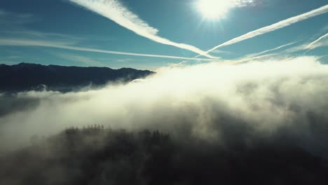 fog over the hills of the mountain village of sirnea in romania