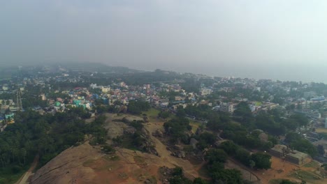 Light-house-of-mamallapuram-situated-among-famous-Rock-cut-Pallava-era-temples,-aerial-view-shot-on-Phantom-4-pro-4K-drone