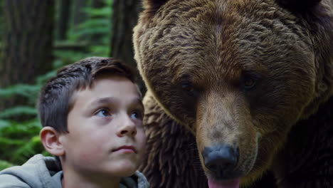 boy and bear in the forest