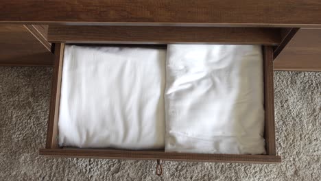 open drawer with clean bed linen