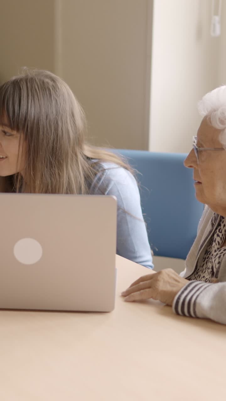 Granddaughter helping to her grandparents to use the laptop