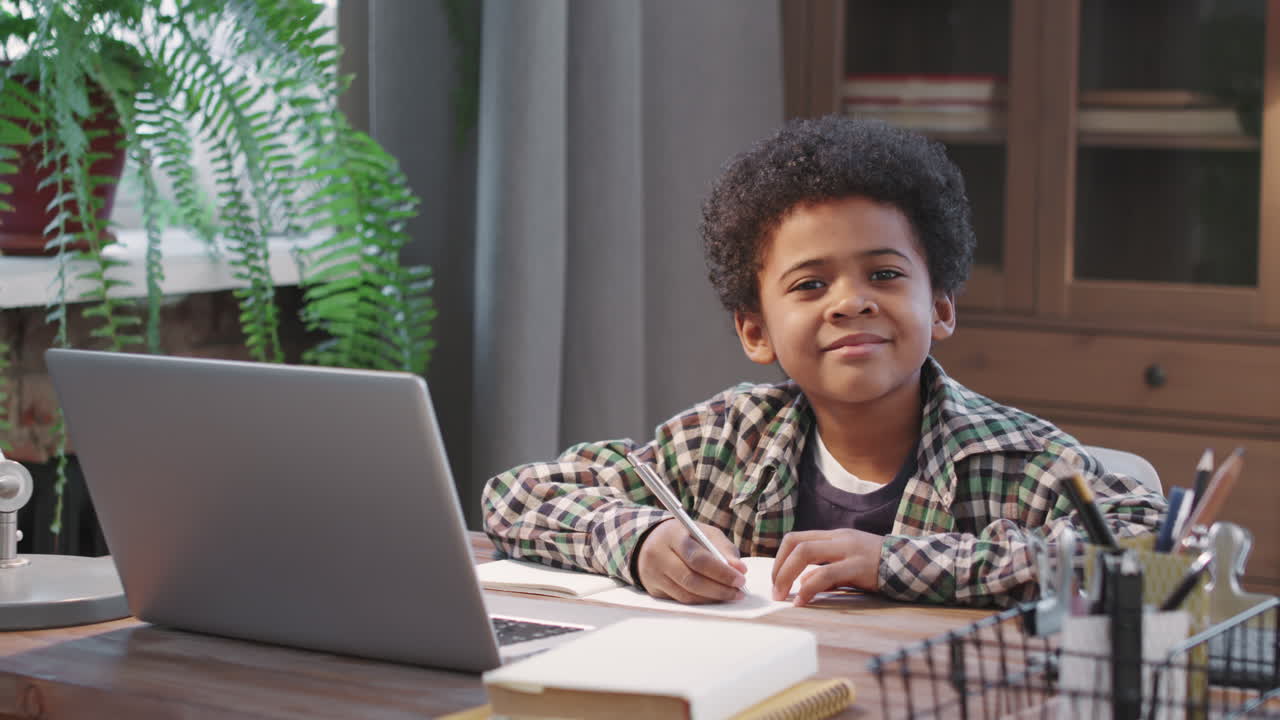 Portrait Of Cute Afro Boy Studying At Home