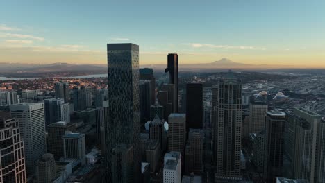 circle pan aerial view of seattle skyline with mount rainier in the distance