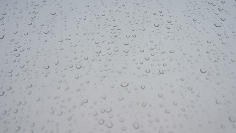 rainy glass pattern as rain drops lays on a window during a gloomy and overcast weather