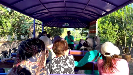 tourists enjoy scenic tram ride in thailand