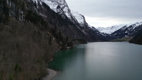 Klöntalersee-Switzerland-Glarus-aerial-along-forest-meeting-famous-lake