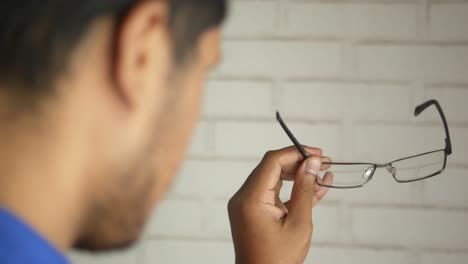 man holding glasses