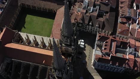 drone flying over gothic spiers and cloister of bayonne cathedral, france