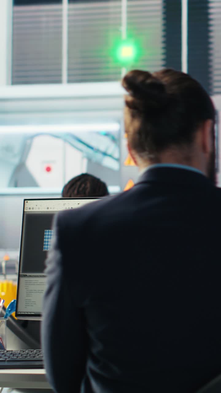 Vertical Video Photovoltaics Factory Engineer Using Laptop To Improve Solar Panels Efficiency