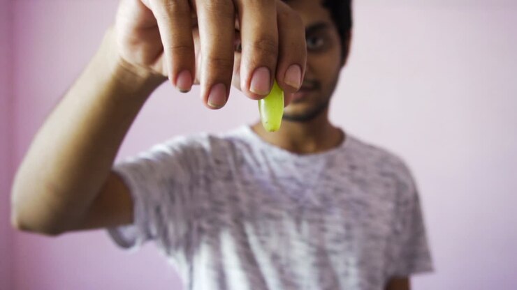 Man taking grapes for fruit salad