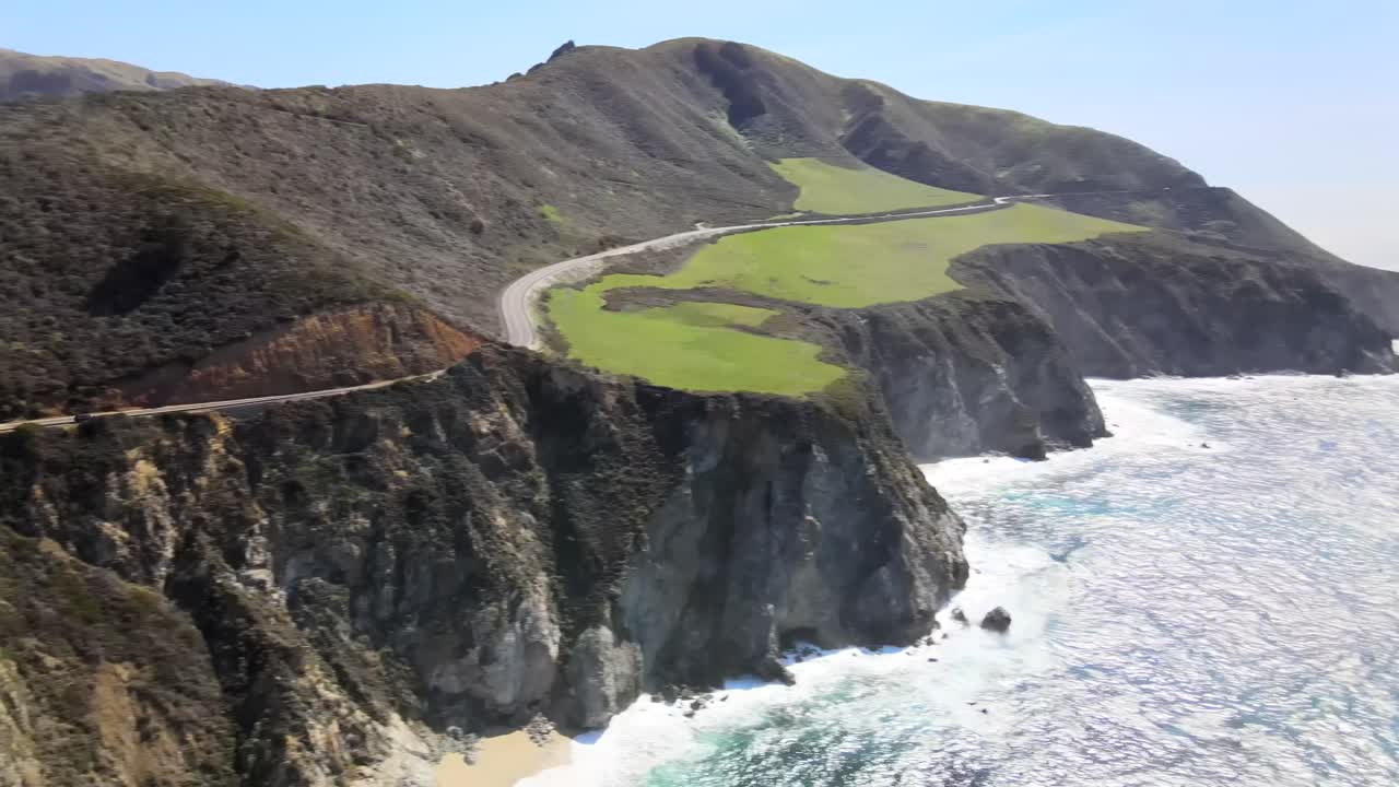 Aerial pan, Bixby Creek Bridge, Big Sur in Pacific Ocean