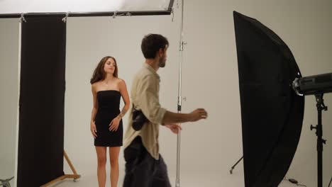 a professional photographer taking pictures of a model in a studio