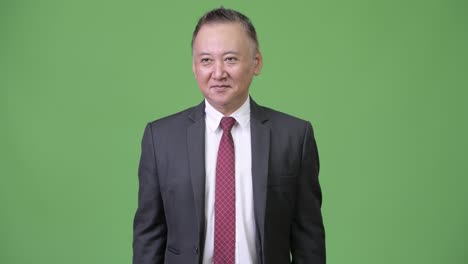 mature japanese businessman giving thumbs up