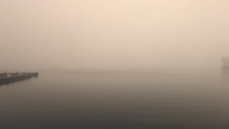 a dock on a misty lake