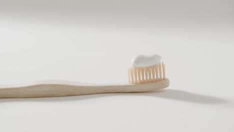 close up of toothbrush with toothpaste on white background with copy space