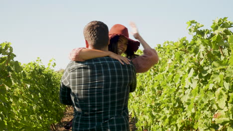 close up of man embracing a woman in the vineyard