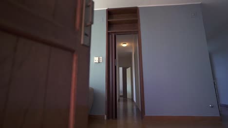 low-angle shot invites viewers into airbnb apartment living room, revealing wooden floor, grey walls, white ceiling, and welcoming couch. perfect for rental listings.