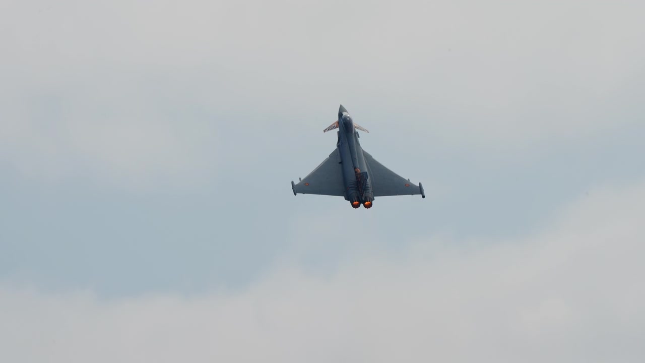 Fighter jet climbing into the clouds