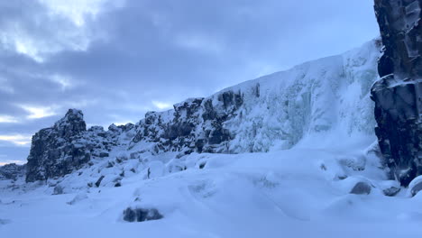 beautifull frozen and with snow covered oxararfoss icefall in winter time in iceland