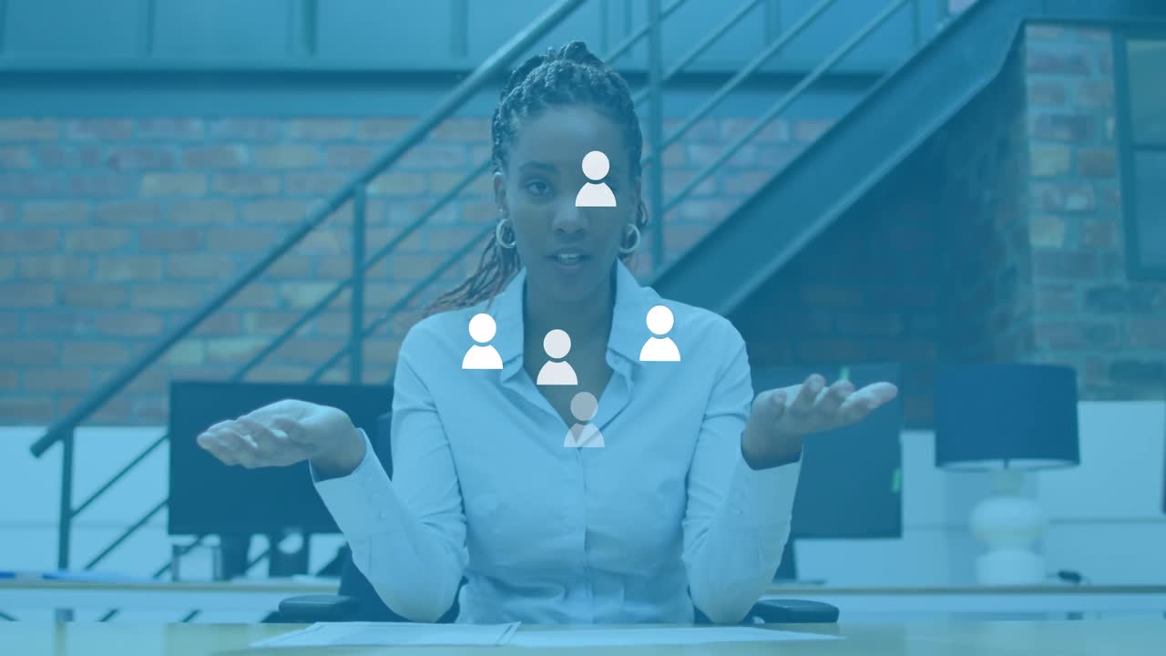 Animation of social media user icons over african american woman in office having video call