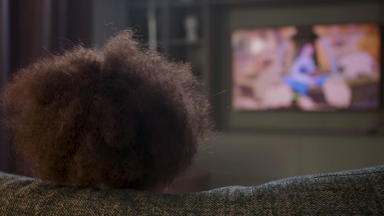 Kid watching film at home