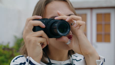 closeup girl taking picture on analog camera. beautiful tourist adjusting lens