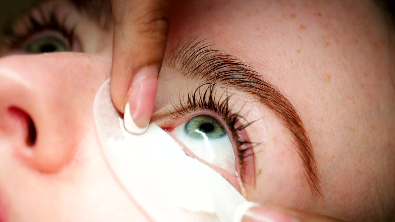 Eyelash extension procedure using protective pads on eyes open