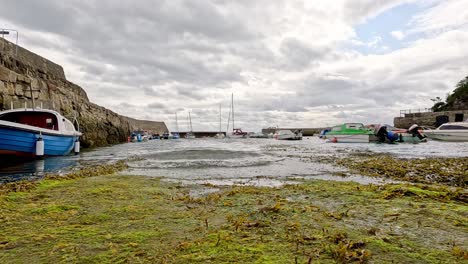 boat approaching pier in fife, scotland