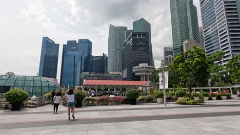 people walking through a bustling city plaza.