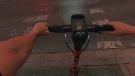 pov sevilla electric scooter mobility early morning commute waitting crossing