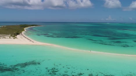 drone shot along sandbank cayo de agua cloudy day, pan right, cayo de agua island los roques