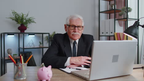 Cheerful-senior-mature-business-office-man-wears-glasses,-formal-suit,-smiling,-looking-at-camera