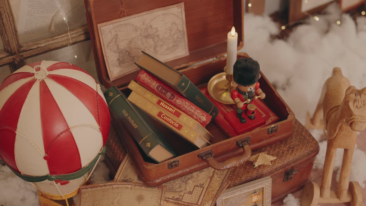 Warm holiday setup with vintage books candle and wooden toy decor