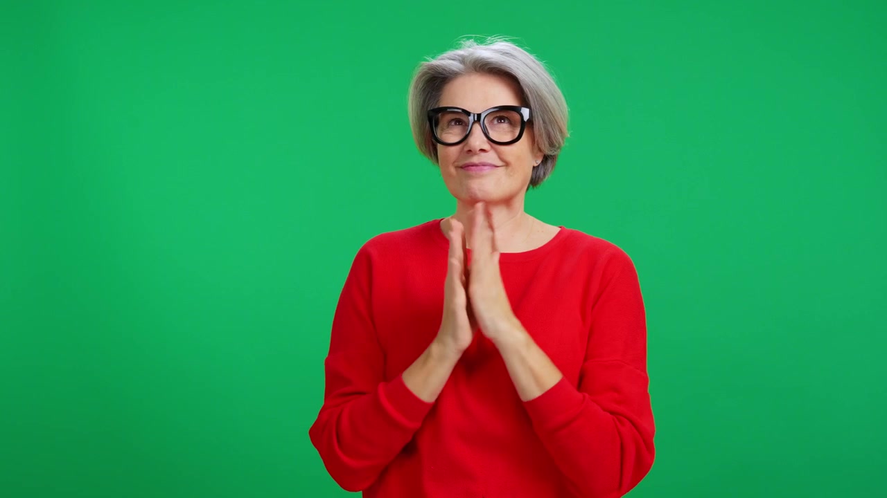 Mature Woman Expressing Various Emotions Against Green Screen