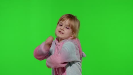 Little-blonde-child-girl-smiling,-dancing,-celebrating-in-unicorn-pajamas-costume-on-chroma-key