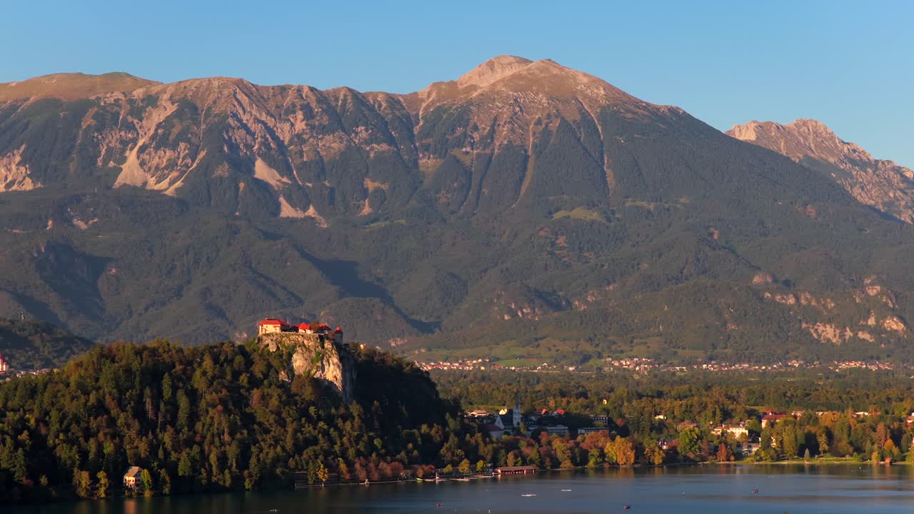 Aerial view of Bled Castle on rock with mountains, Slovenia, travel mood