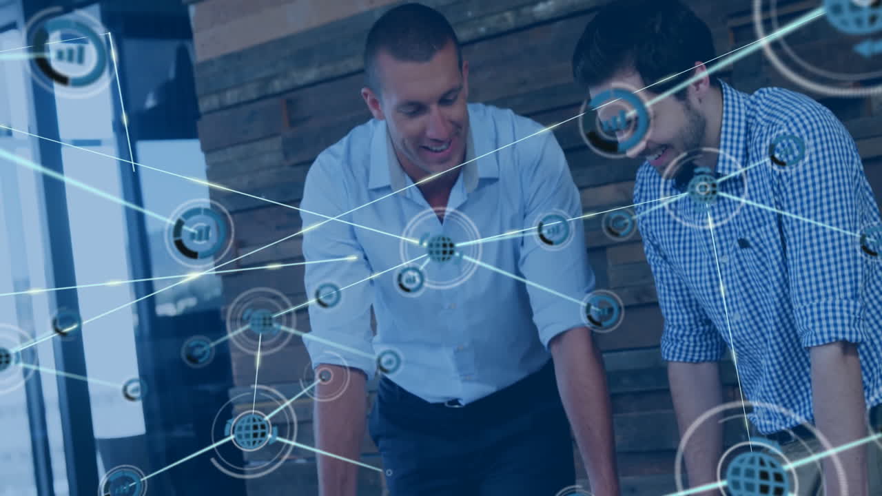 In office, businessmen collaborating using digital network overlay animation on laptops