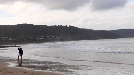 person walking on lorne beach, melbourne