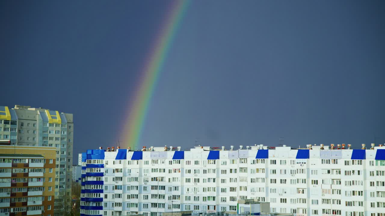Rainbow over City Buildings