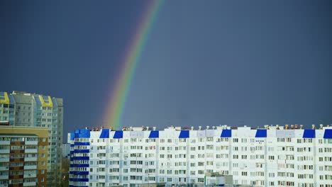 rainbow over city buildings