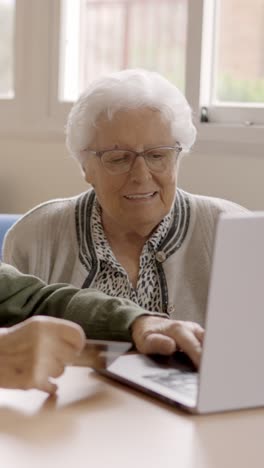senior people shopping online using credit card and laptop