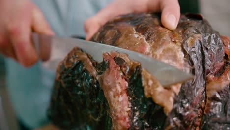 chef slicing the steak with steel knife