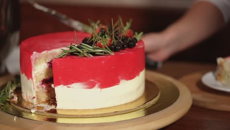 chef cutting a deliciously decorated red velvet cake